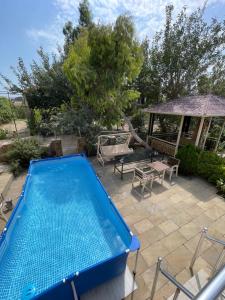 a swimming pool in a yard with a gazebo at Serenity Garden Home in Sumqayıt