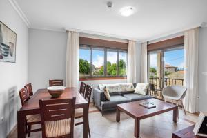 a living room with a couch and a table at Apartamentos Casa Ameirós in O Grove