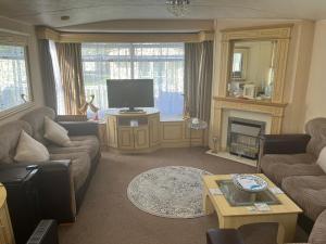 a living room with two couches and a television at Cosy holiday home in Warden
