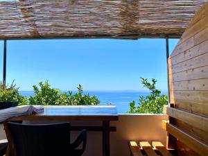 a table and chairs on a balcony with a view of the ocean at Erika's House in Lukovë