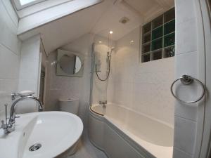 a bathroom with a sink and a tub and a toilet at Duddon Valley Retreat, Lake District National Park, Sleeps 7 in Broughton in Furness