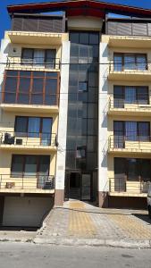 an apartment building with balconies on the side of it at Apartament Mamaia-Nord 5min de mers pe plaja in Mamaia Nord