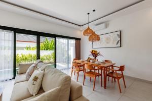 a living room with a couch and a table at ND LOFT 2 by Kasta Hospitality in Canggu