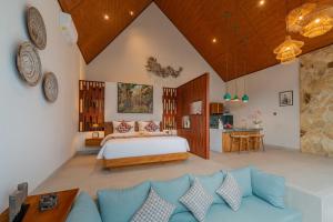 a bedroom with a bed and a couch in a room at Greha Natha Villa Ubud in Ubud +95 photos