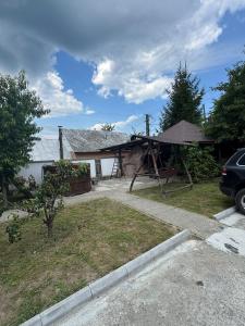 a house with a gazebo in the yard at Casa Vlad-Alex in Săpânța