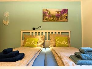 two beds with pillows on them in a bedroom at Apartment - direkt am Fluss, balkon, rustikal, idylisch in Grünau im Almtal