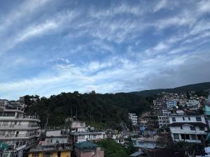 a view of a city with buildings and trees at Nya Abode in Shillong