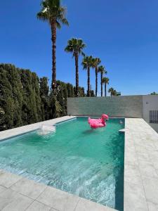 a swimming pool with a pink elephant in the water at Casa rural , campo ocio, eventos, Villa Rural in Dos Hermanas