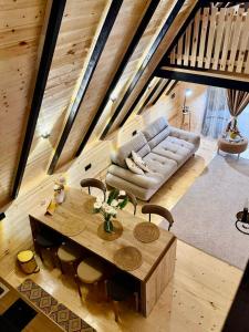 a living room with a couch and a table at Oda to Didvela -ოდა დიდველაში 