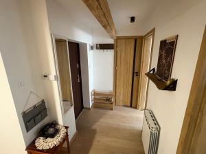 a hallway of a room with a couch and a door at Mazurski strych in Węgorzewo