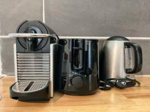a coffee maker and a toaster sitting on a counter at La Prom 2 - a two bedroom apartment with a sea view in Nice