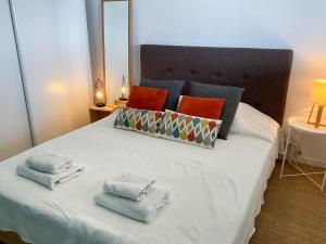 a bedroom with a bed with towels on it at La Prom 2 - a two bedroom apartment with a sea view in Nice