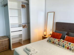 a small bedroom with a bed and a mirror at La Prom 2 - a two bedroom apartment with a sea view in Nice +23 photos