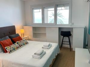 a bedroom with a bed with towels on it at La Prom 2 - a two bedroom apartment with a sea view in Nice