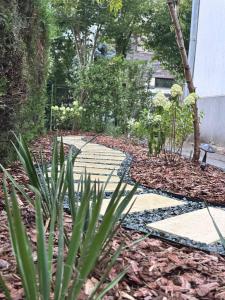 a garden with a stone walkway and plants at Villa am Schwarzen Meer in Eforie Nord