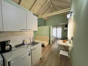 a kitchen and a living room with a couch at Ktima Klimentini in Vivari