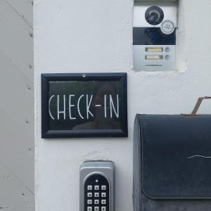 a check in sign on a wall with a remote control at Koje1 in Bremm