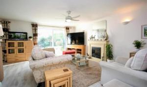 a living room with two couches and a tv at 1-Bed Seaside Retreat - Sleeps 2 Parking & Garden in Peacehaven