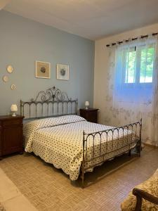 a bedroom with a bed and a window at Casa Stefania in Pomino +10 photos