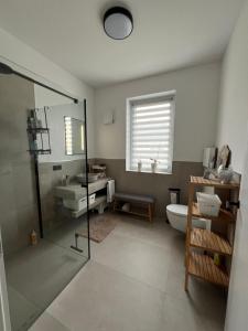 a bathroom with a shower and a toilet and a sink at Moderne Ferienwohnung nahe Worpswede und Bremen-stilvoll & zentral in Lilienthal +11 photos
