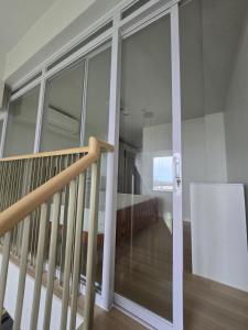 a bedroom with sliding glass doors and a staircase at Mandani Bay Suites Tower 2 - Cebu City in Mandaue City