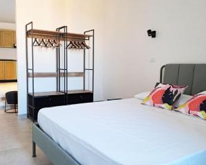 a bedroom with a large white bed with pillows at B&B L'alba Nel Golfo in Castelsardo