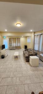 a large room with a bed and a table at House in Niagara falls, Close to Clifton Hill, Casino and Horseshoe falls and with kitchen for 6 Guest in Niagara Falls +19 photos