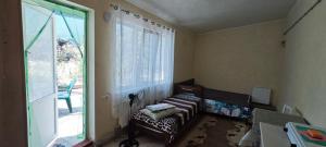 a living room with a couch and a large window at Домик у Ляны in Vapnyarka +28 photos