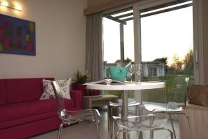 a living room with a couch and a table with chairs at Costa Verde Natura in Clusane sul Lago