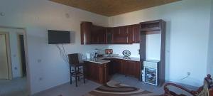 a kitchen with wooden cabinets and a counter top at Lake of Diber in Debar