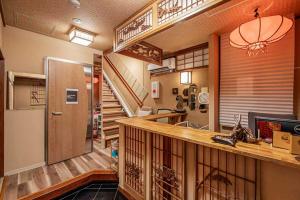 a kitchen with a counter and a staircase in a room at Hotel Ginnan in Tokyo