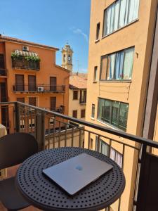 a laptop sitting on top of a table on a balcony at 3 Amici all'Arena in Verona