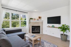 a living room with a couch and a fireplace at Walkable Seattle Gem Close To Everything condo in Seattle