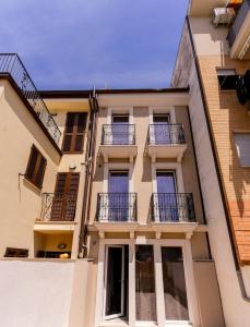 a building with balconies on the side of it at Chic Suite Wi-Fi and Climate in Porto SantʼElpidio