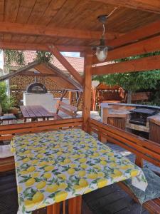 a covered deck with a bed on a patio at Patrícia Panzió in Bük