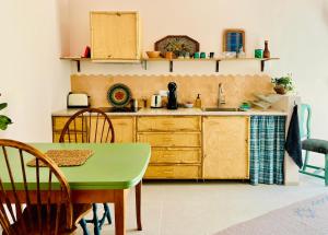 a kitchen with a table and a sink at Studio Indigo in Aljezur
