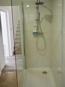 a shower with a glass door next to a staircase at Villa Les Rosiers private parking in Le Touquet-Paris-Plage +21 photos