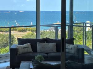 卡朗泰克Maison de Vacances - Vue mer avec Piscine的带沙发的客厅，可欣赏海景