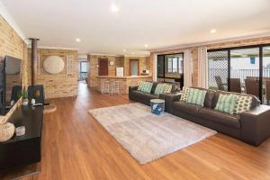 a living room with a couch and a table at Duke Street Hideaway in Busselton