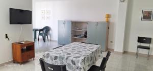 a living room with a table and a tv at "Casa Simone" in Leverano