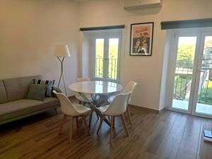 a living room with a table and chairs and a couch at Casa Tina in Venaria Reale +8 photos