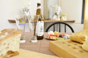 eine Flasche Wein und Gläser auf dem Tisch in der Unterkunft Casa Vacanza Viale Arbatax in Tortolì