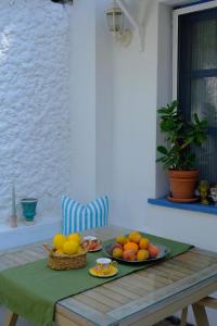 a table with a plate of fruit on it at Eden in Teos Pansiyon in Seferihisar