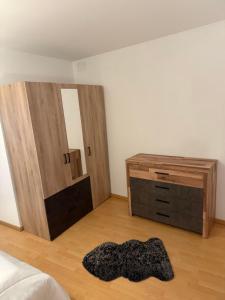 a bedroom with a bed and a dresser and a mirror at Appartement chaleureux in Remiremont