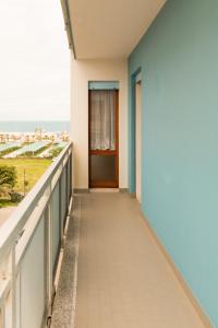 a balcony with a door and a view of the ocean at Hotel Sabrina in Sottomarina