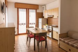 a kitchen with a table and chairs in a room at Hotel Sabrina in Sottomarina +24 photos