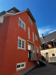 a red building with a balcony on the side at NEU ... in 2 min. am Bodensee in Überlingen
