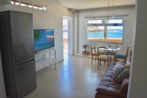 a living room with a couch and a tv and a table at Ian's House in La Garita