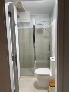 a bathroom with a shower and a white toilet at Ian's House in La Garita +8 photos