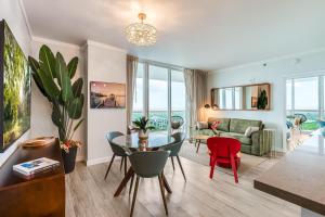 a living room with a table and chairs and a couch at Elegant 2BR Condo at Hotel Arya Full Kitchen Wraparound Views 2 Parking Spots in Miami